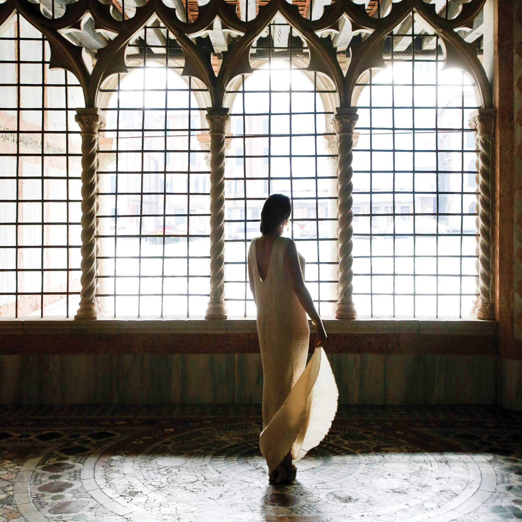 Woman in Fortuny dress in Venetian palace
